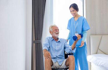 Obraz premium Hospice nurse is helping Caucasian man in wheelchair to exercising muscle strength in pension retirement center for home care rehabilitation and post treatment recovery process