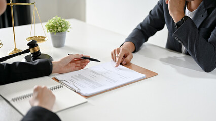A professional male lawyer has a meeting with a client to provide counseling and give advice