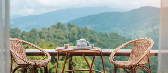 teapot set on table in the morning with mountain view at countryside home or homestay. Vacation,...