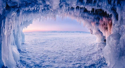 Foto op Canvas Blue Ice cave or grotto on winter lake Baikal. Beautiful winter landscape with long icicles © Parilov