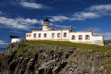 Fototapeta na wymiar Neist Point Lighthouse Under a Blue Sky on Isle of Skye