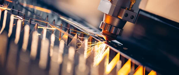Foto op Canvas Macro CNC laser machine cutting sheet metal with light spark. Technology plasma industrial banner, Blue steel color © Parilov
