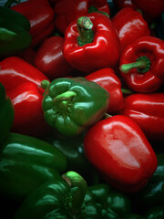 Red and green sweet bell pepper in dark scene