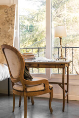 antique chair and desk by a window - quilt on the table