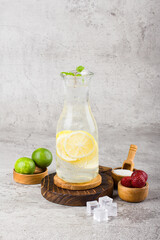 iced lemon with sparkling soda water on wooden coaster and white background texture