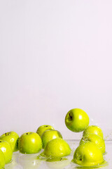 Green apples fall into the water, a place for text