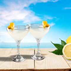 Two glasses with fresh homemade cocktail on a table at summer evening,