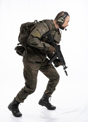 soldier in the studio on a white background. a man in military uniform with a rifle or machine gun. military or airball player