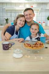 Portrait of Happy Family of Three Enjoying Breakfast in the Kitchen at Home