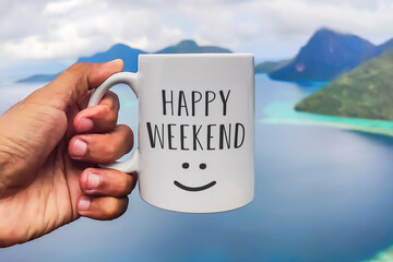 Weekend greeting on white coffee or tea cup in hand on sea background. Happy weekend
