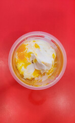 Photo from the top of a cup of ice cream with mango jam