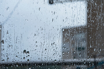 Wet rain drops on window glass season mood natural