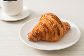 fresh croissant on white plate