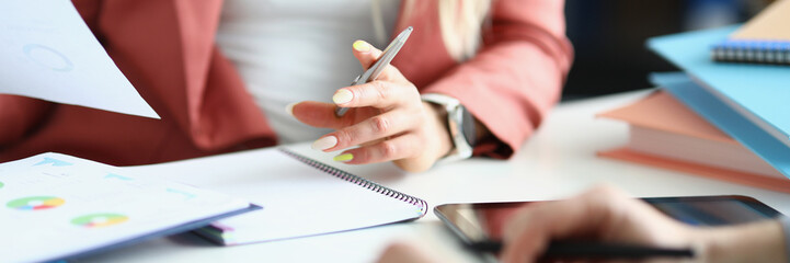 Coworkers discussing working moments and checking financial report