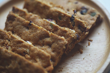 Healthy snack whole grains cookie crackers on a wooden plate white marble background rectangular shape closeup view