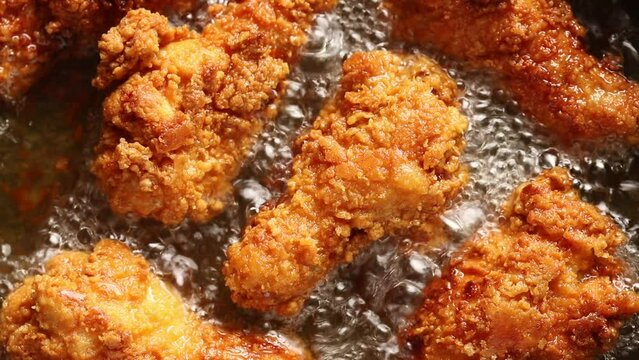 Top view of Crispy Chicken Drumsticks are Fried in Boiling Oil