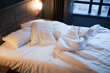 Fototapeta premium messy bed in early morning , messy bed after waking up 