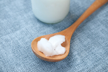 spoon with cold coconut oil on table 