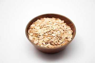 Oat flakes in a wooden bowl