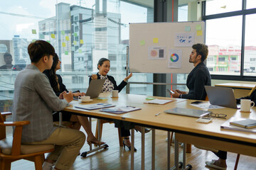 Meeting of Asian business people who are committed to work. Creative business team working together at office.