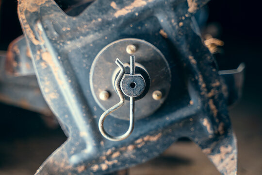 Spring cotter pin close-up on the axis of the cultivator