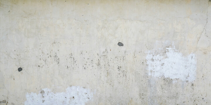 cement grayish white plaster aged wall of a house facade for use as a background in web header format
