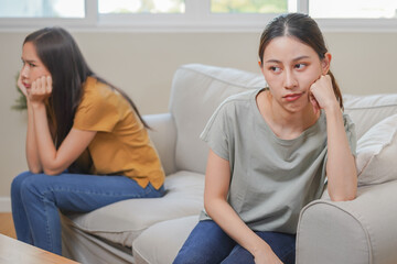 Unhappy lesbian, lgbt asian young two women, girl gay, couple love fight on sofa, relationship is...