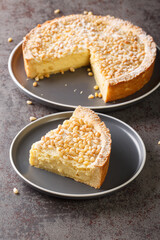 Custard cream cake with pine nuts torta della nonna or grandmother's cake closeup in the plate on the table. Vertical