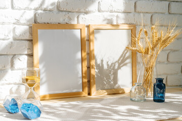 Photo frames on a brick wall background on the table with wheat ears in vase