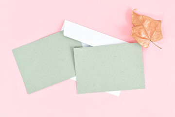 Greeting card mockup with envelope on pink background. Card mockup with copy space.