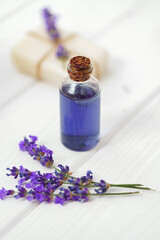 Lavender soap bars and spa products with lavender flowers on a white wooden table