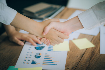 The atmosphere in the meeting room where the businessmen are meeting, information papers and charts are placed on the table to support the business planning meeting to grow. Business idea