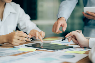 The atmosphere in the meeting room where the businessmen are meeting, information papers and charts are placed on the table to support the business planning meeting to grow. Business idea