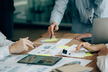 The atmosphere in the meeting room where the businessmen are meeting, information papers and charts are placed on the table to support the business planning meeting to grow. Business idea