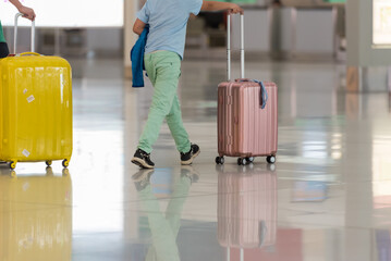 People carries luggage at the airport terminal and hurry up for check in on holiday or business trip.