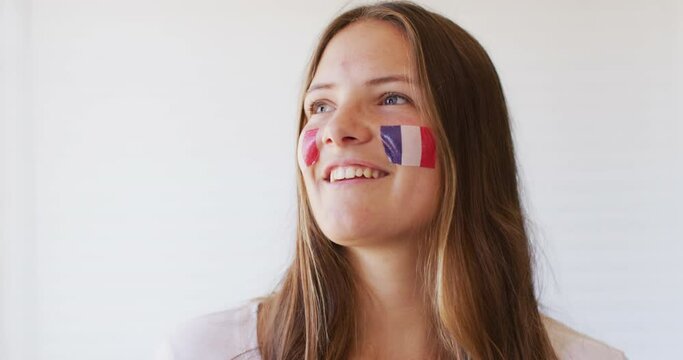 Image of happy caucasian woman with flag of france cheering