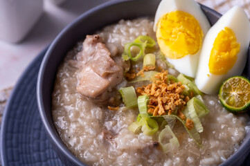Arroz caldo, is a Filipino rice and chicken gruel heavily infused with ginger and garnished with toasted garlic, scallions, and black pepper. It is usually served with calamansi or fish sauce (patis) 