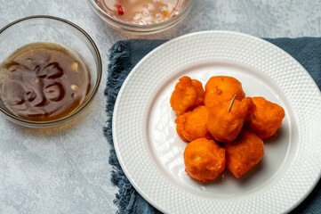 Tokneneng or tukneneng is a tempura-like Filipino street food made by deep-frying orange batter covered hard-boiled chicken or duck eggs. A popular variation of tokneneng is kwek kwek. 