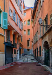 Fototapeta premium Narrow crooked street in the Old Town, Vieille Ville in Nice, French Riviera