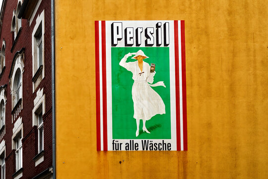 Sebnitz, Germany, July 6, 2022: Persil detergent, advertisement of the German concern Henkel from historical times on a yellow house wall