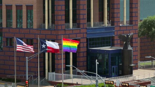 Houston Federal Courthouse. USA, Texas, Rainbow flags. Rising aerial reveal during LGBTQ Pride Month in America. Obergefell versus Hodges Supreme Court Case theme.