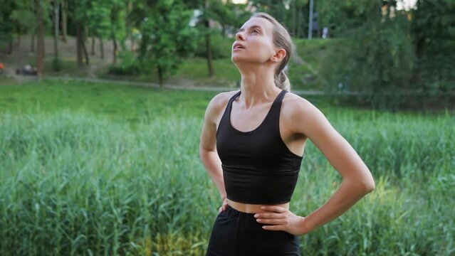 Stomach pain. Close-up of pretty female athlete sportswoman having pain in stomach during workout outdoor. Runner feeling acute liver pain, gallbladder inflammation, girl athlete suffering from pain.