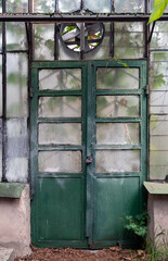 Old metal doors with weathered and faded paint. Dirty, dusty glass. Abstract background. Vintage.