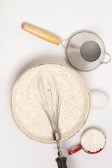 MIxing baking ingredients with dry yeast isolated on white background