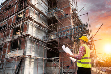 Construction engineers use radios to control work at construction sites. industrial workers wearing...