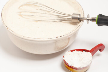 MIxing baking ingredients with dry yeast isolated on white background