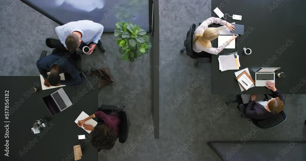 Poster Above view of corprate manager walking, greeting and checking diverse team of colleagues and businesspeople in the morning at the office. Group of men, women and lawyers using laptops and paperwork
