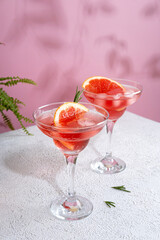 Summer refreshing sparcling cocktails with grapefruit. Lemonade garnished with fresh rosemary. Summer beverage with sparkling water and grapefruit slices.