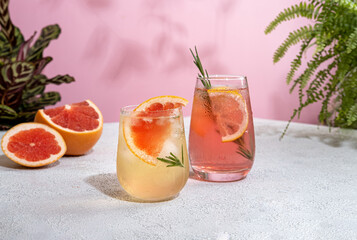 Summer refreshing sparcling cocktails with grapefruit. Lemonade garnished with fresh rosemary....