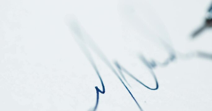 Close up of the selective focus of trying to Sign documents. Detail shot making a signature on a blank sheet of paper. Slow motion